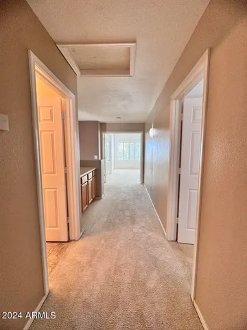 a view of a white house with a yard