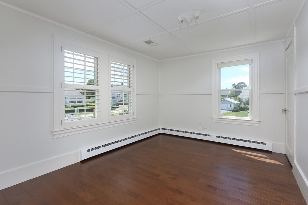 11 Bryant Road Bourne, MA 02532 - Photo 20 of 28 an empty room with wooden floor and windows