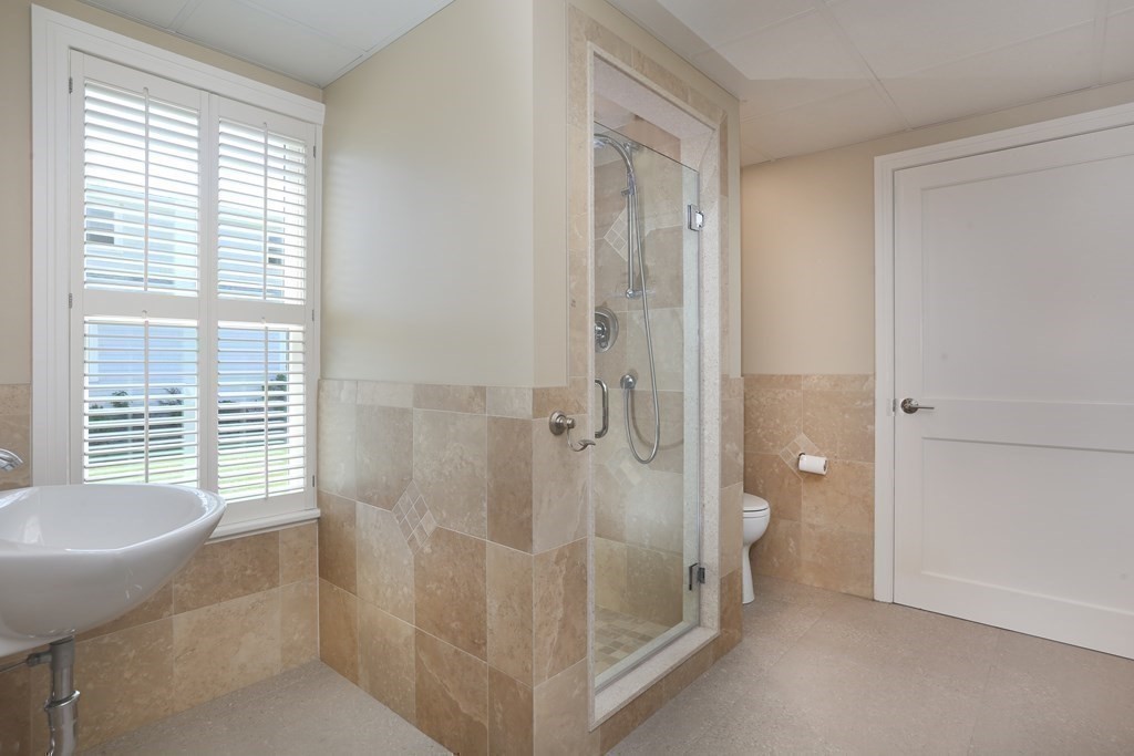 11 Bryant Road Bourne, MA 02532 - Photo 22 of 28 a bathroom with a granite countertop sink a toilet and shower