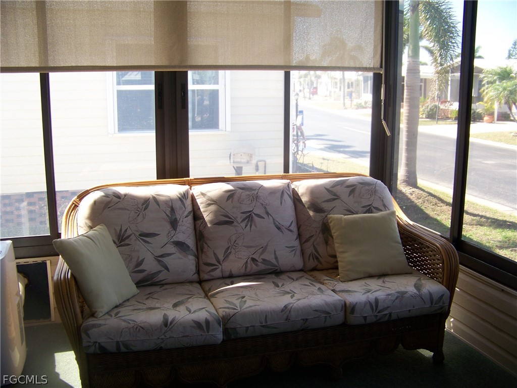 15550 Burnt Store Road, Unit 72 Punta Gorda, FL 33955 - Photo 13 of 50 a living room with couches and a large window with rug