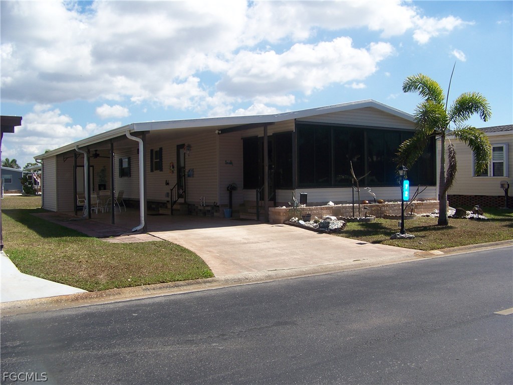 15550 Burnt Store Road, Unit 72 Punta Gorda, FL 33955 - Photo 2 of 50 a view of a house with backyard and porch