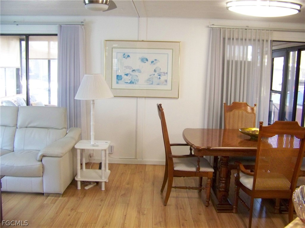 15550 Burnt Store Road, Unit 72 Punta Gorda, FL 33955 - Photo 23 of 50 a view of a dining room with furniture and wooden floor