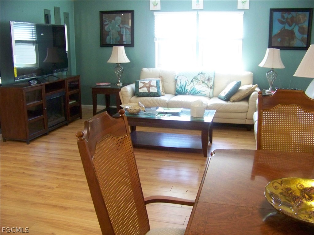 15550 Burnt Store Road, Unit 72 Punta Gorda, FL 33955 - Photo 24 of 50 a living room with furniture and a flat screen tv