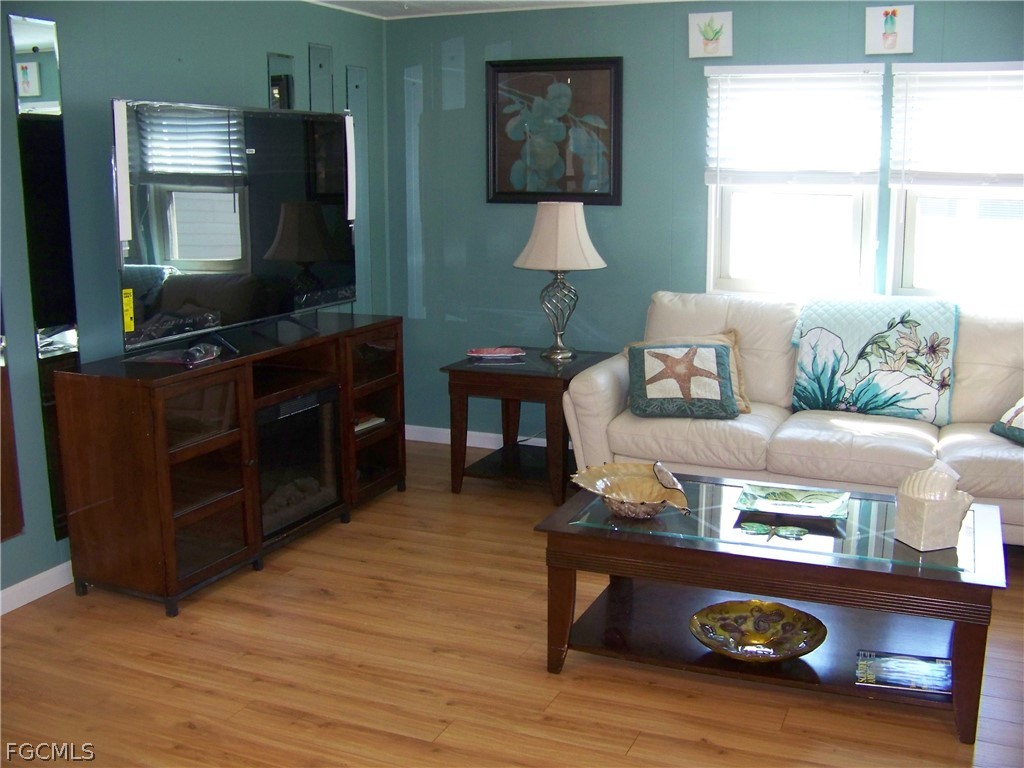 15550 Burnt Store Road, Unit 72 Punta Gorda, FL 33955 - Photo 26 of 50 a living room with furniture and a flat screen tv