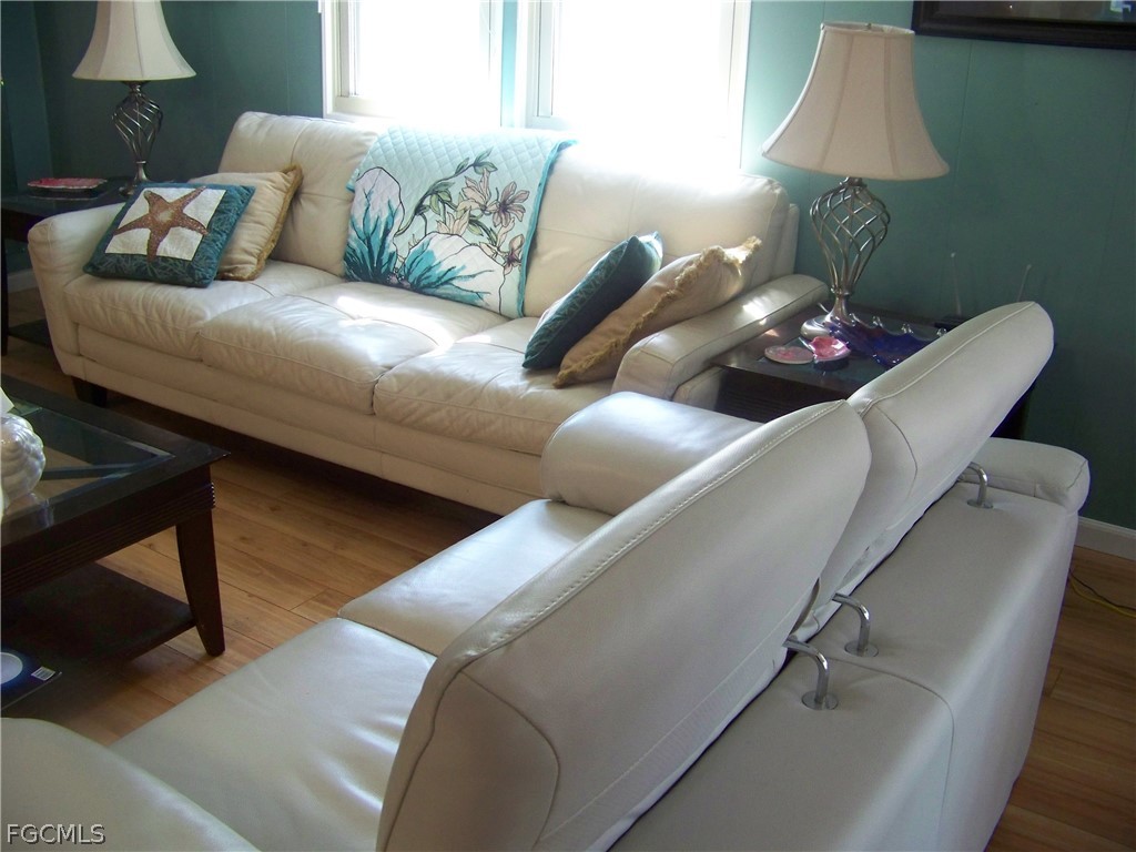 15550 Burnt Store Road, Unit 72 Punta Gorda, FL 33955 - Photo 27 of 50 a living room with furniture and a lamp