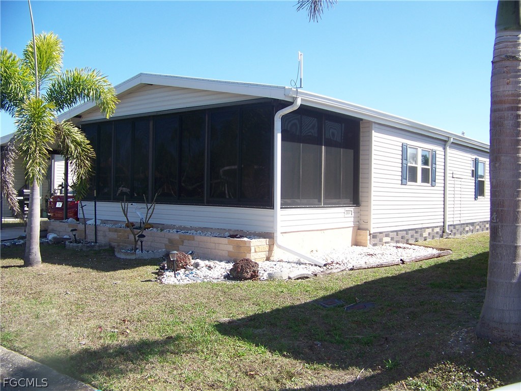 15550 Burnt Store Road, Unit 72 Punta Gorda, FL 33955 - Photo 3 of 50 a front view of a house with garden