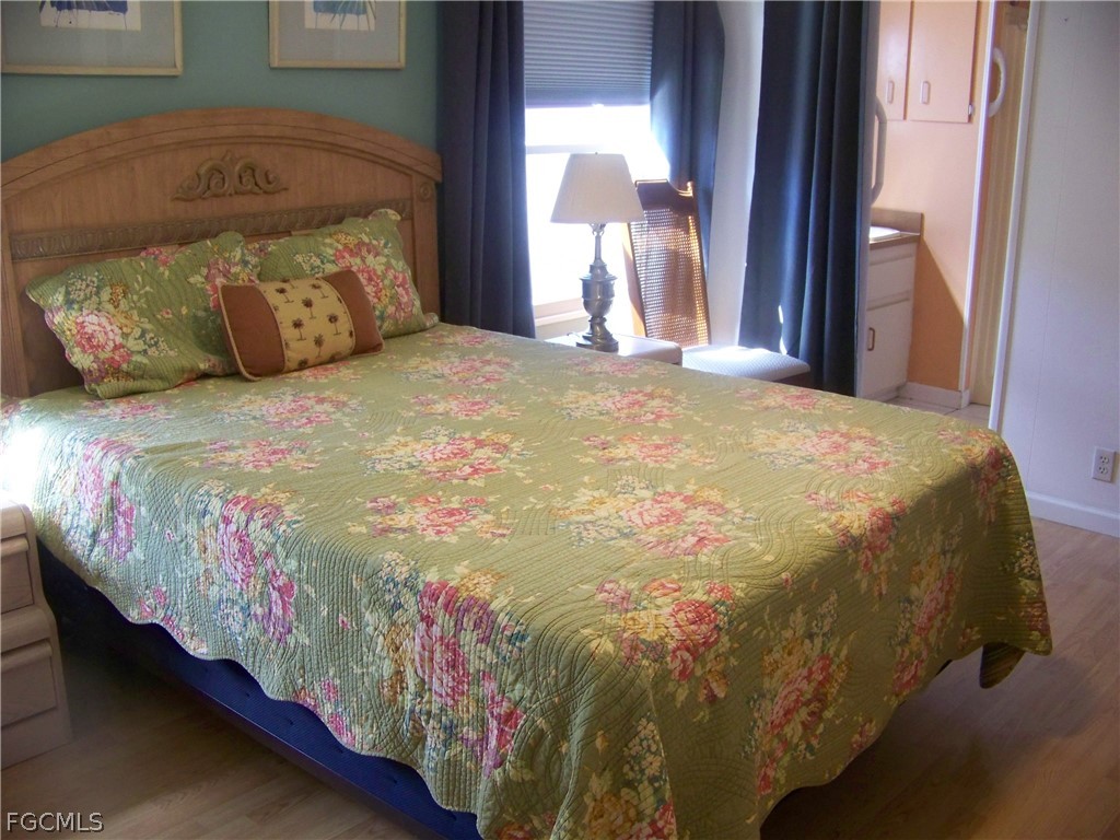 15550 Burnt Store Road, Unit 72 Punta Gorda, FL 33955 - Photo 31 of 50 a bed sitting in a bedroom next to a window