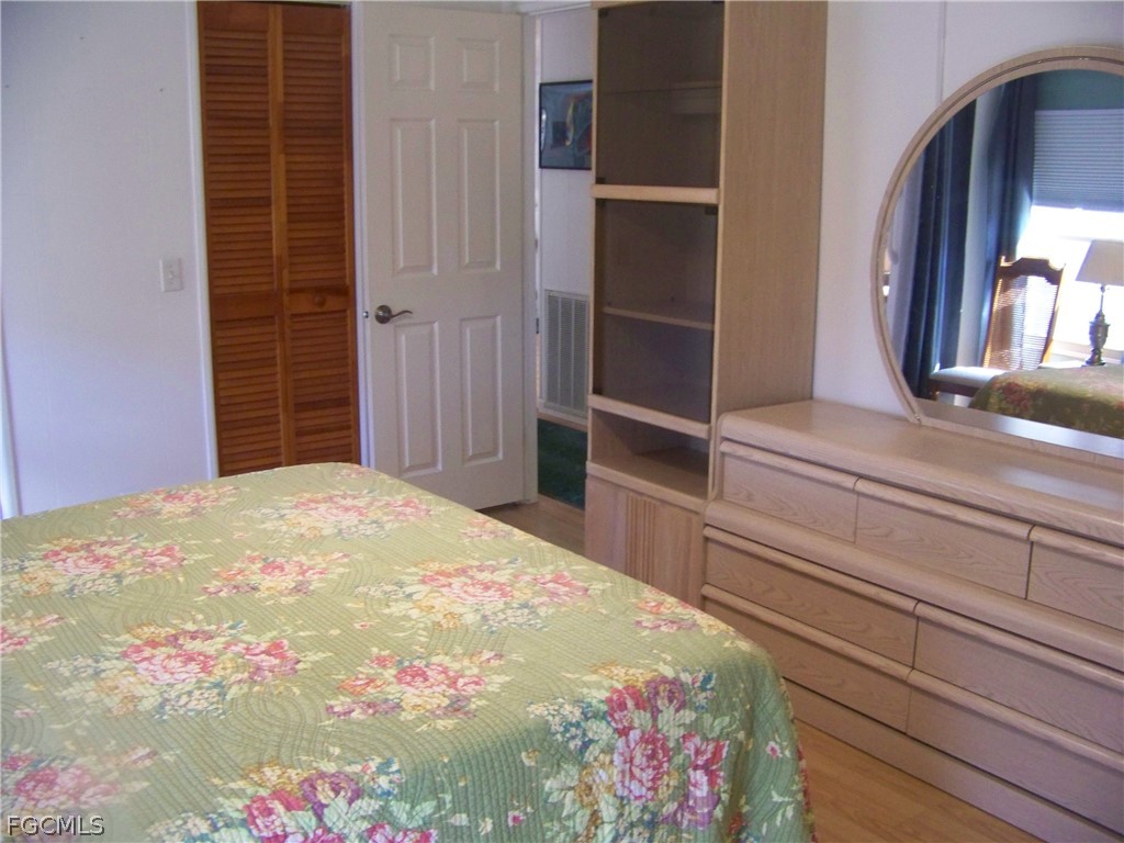 15550 Burnt Store Road, Unit 72 Punta Gorda, FL 33955 - Photo 32 of 50 a bedroom with a bed and a dresser