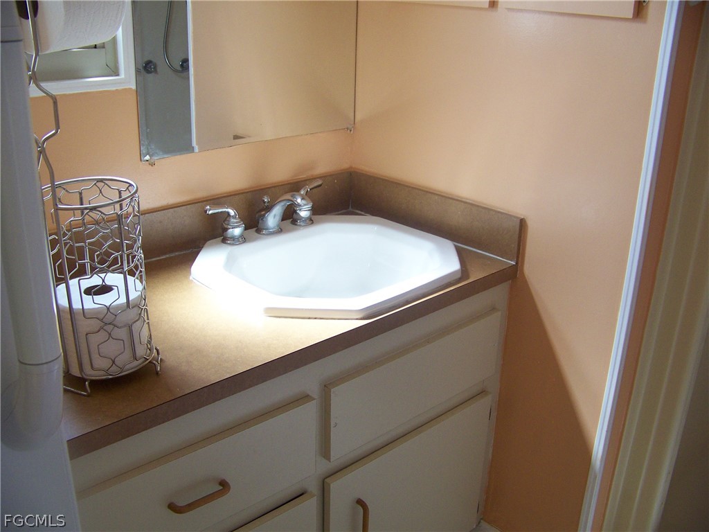 15550 Burnt Store Road, Unit 72 Punta Gorda, FL 33955 - Photo 35 of 50 a bathroom with a sink and a mirror