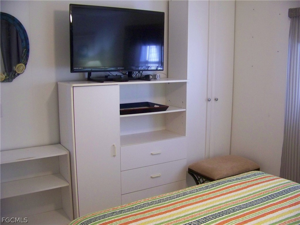 15550 Burnt Store Road, Unit 72 Punta Gorda, FL 33955 - Photo 37 of 50 a bedroom with a bed and a television