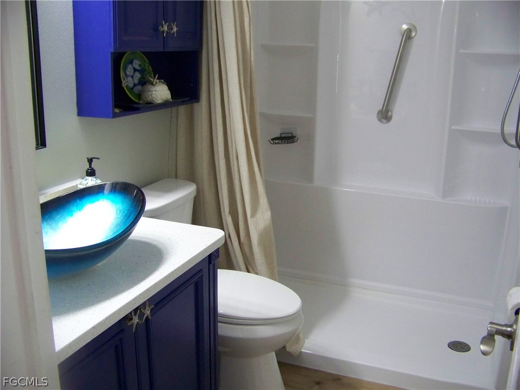 15550 Burnt Store Road, Unit 72 Punta Gorda, FL 33955 - Photo 38 of 50 a bathroom with a sink and mirror with toilet