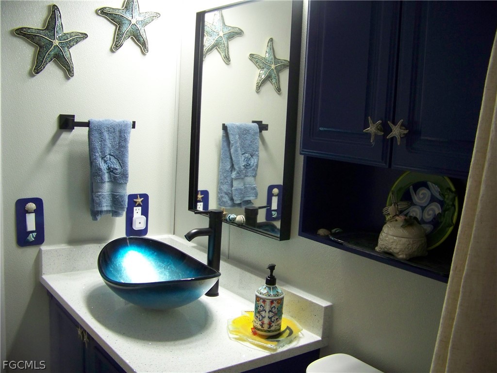 15550 Burnt Store Road, Unit 72 Punta Gorda, FL 33955 - Photo 39 of 50 a bathroom with a sink and a mirror