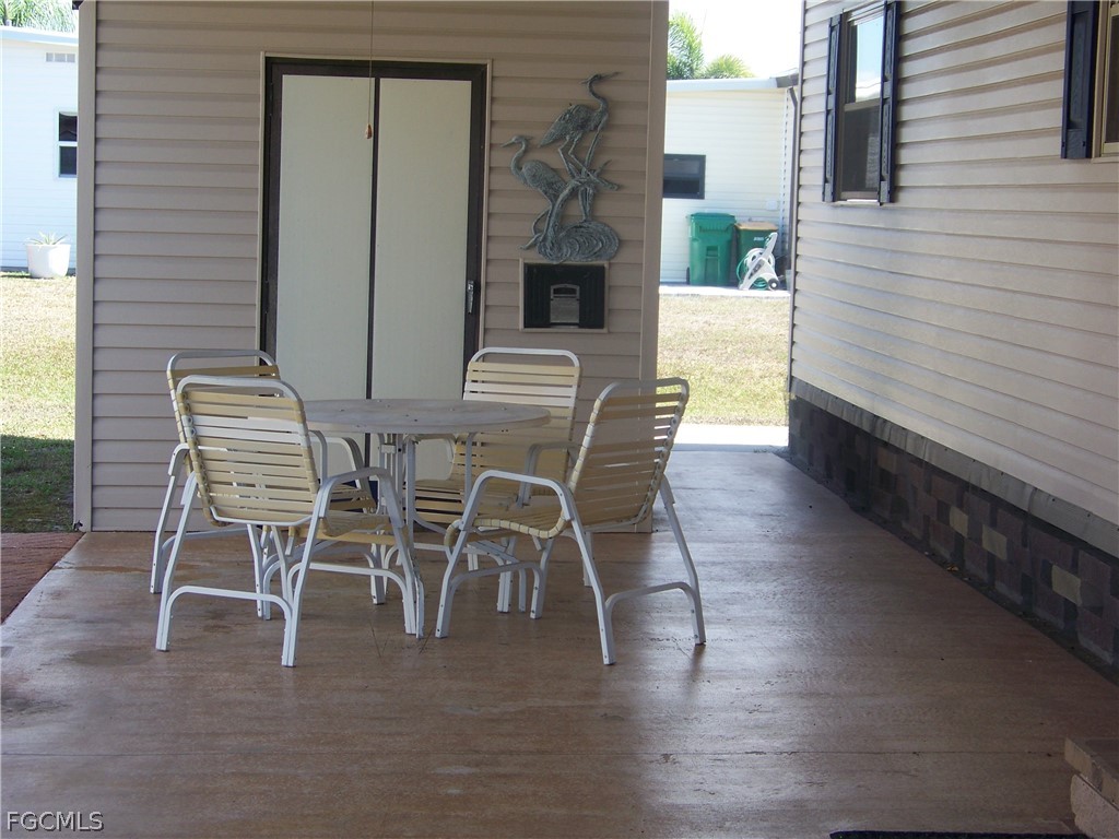 15550 Burnt Store Road, Unit 72 Punta Gorda, FL 33955 - Photo 8 of 50 a patio with table and chairs