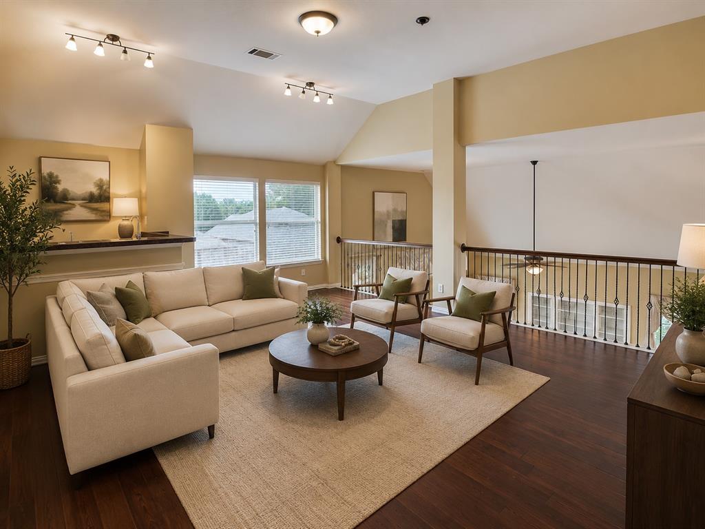 5708 Rickshaw Lane Plano, TX 75094 - Photo 19 of 28 Hardwood-style flooring throughout this open-concept room features an angled ceiling with track lighting