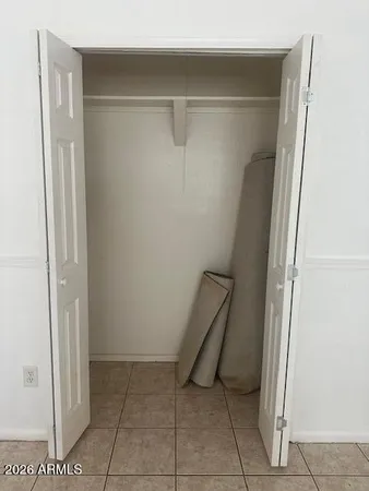 a backyard of a house with barbeque oven table and chairs