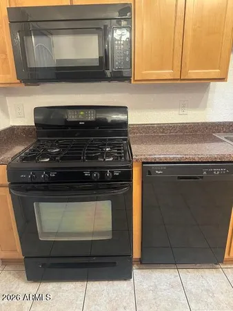 a stove top oven sitting inside of a kitchen