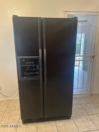 a view of a refrigerator in kitchen