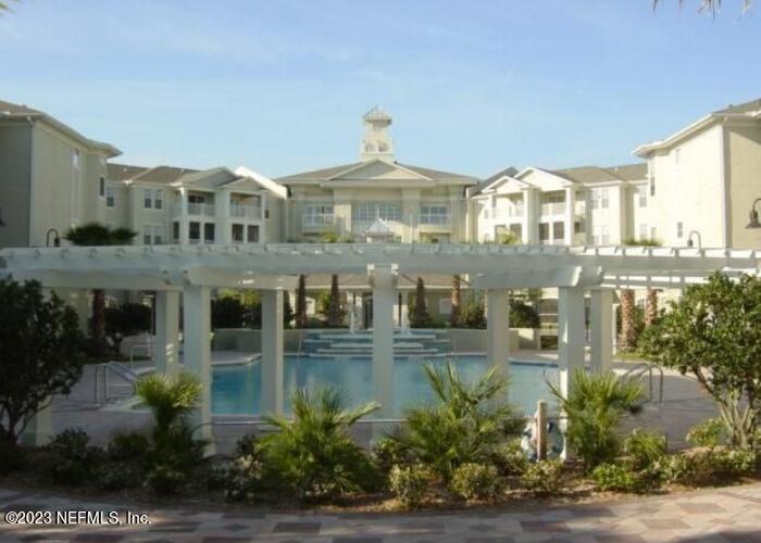8290 Gate Parkway West, Unit 149 Jacksonville, FL 32216 - Photo 3 of 14 a front view of a house with a yard