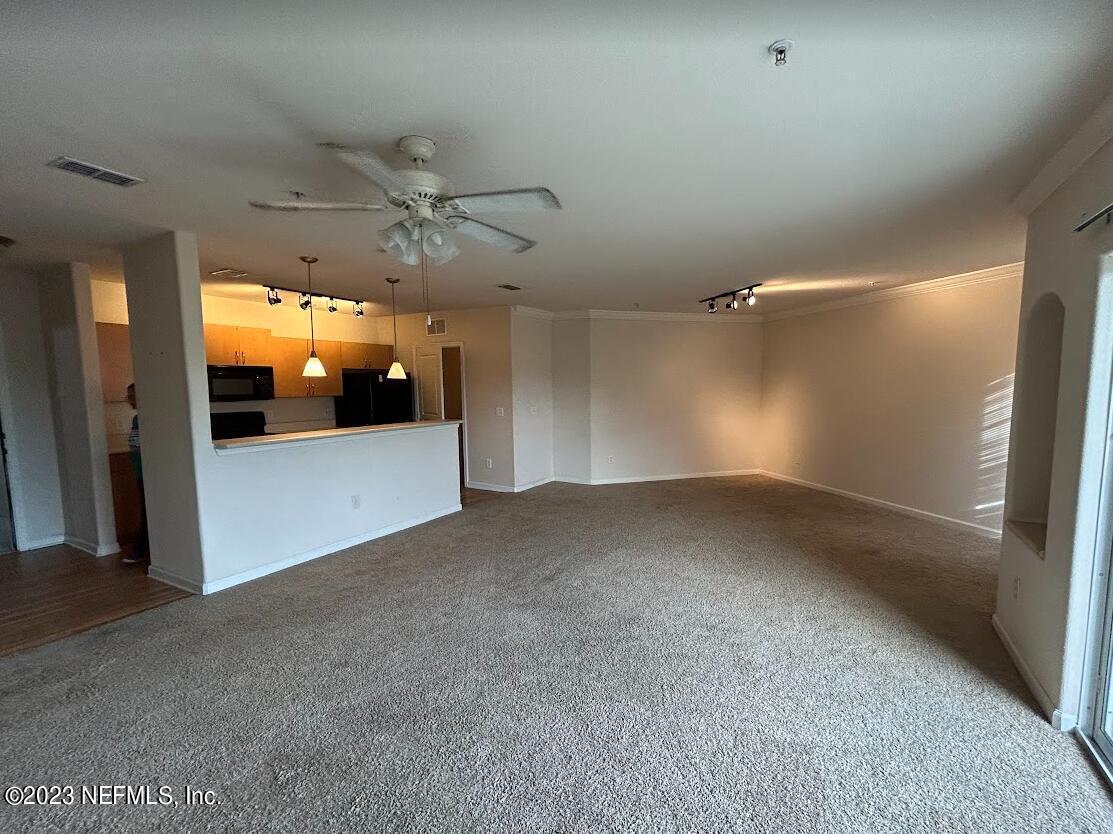 8290 Gate Parkway West, Unit 149 Jacksonville, FL 32216 - Photo 6 of 14 a view of a livingroom with a ceiling fan and window