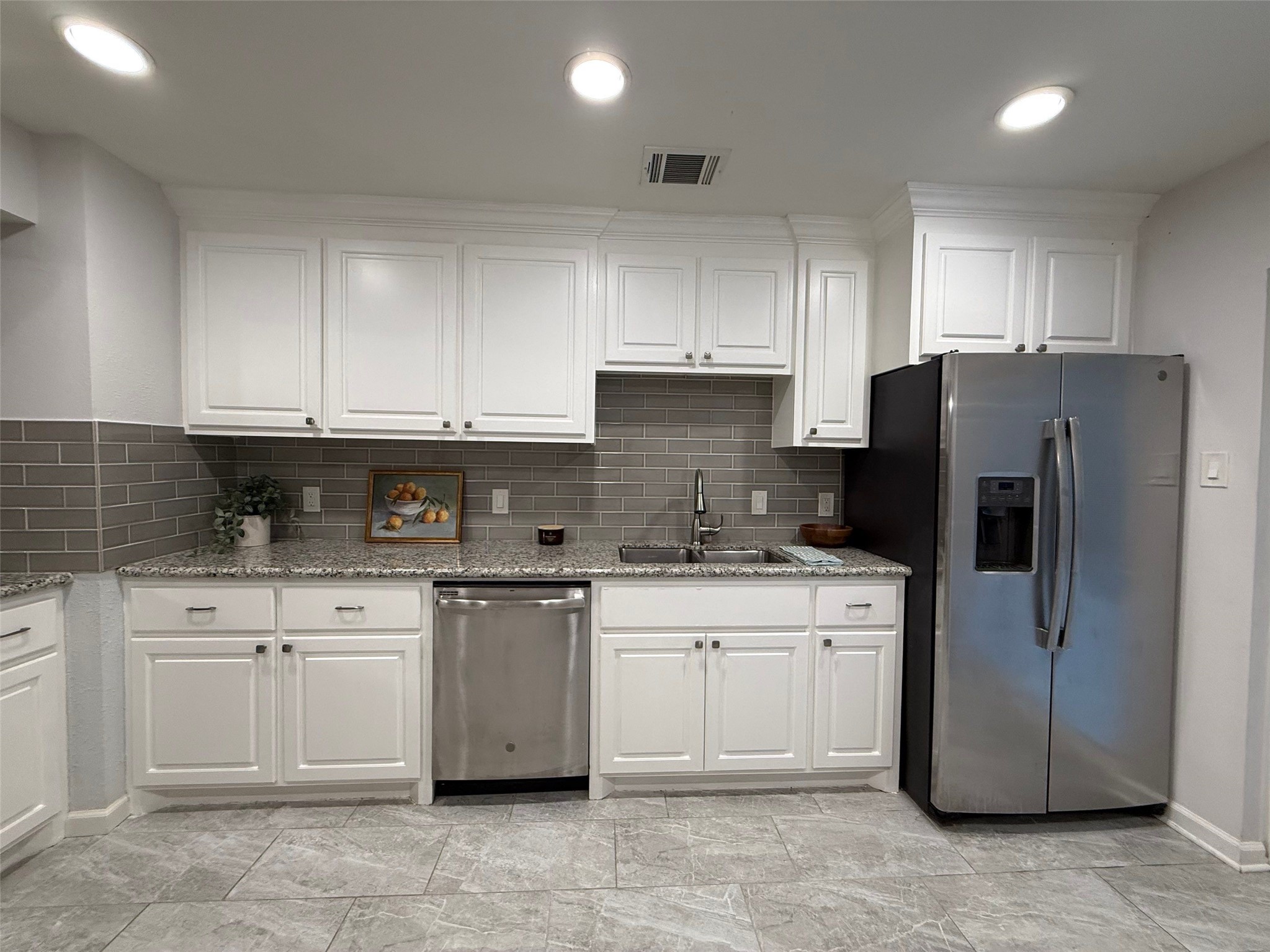 9626 Magnolia Ridge Drive Houston, TX 77070 - Photo 12 of 40 a kitchen with a refrigerator sink and cabinets