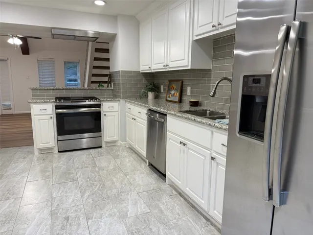 a stove top oven sitting inside of a kitchen