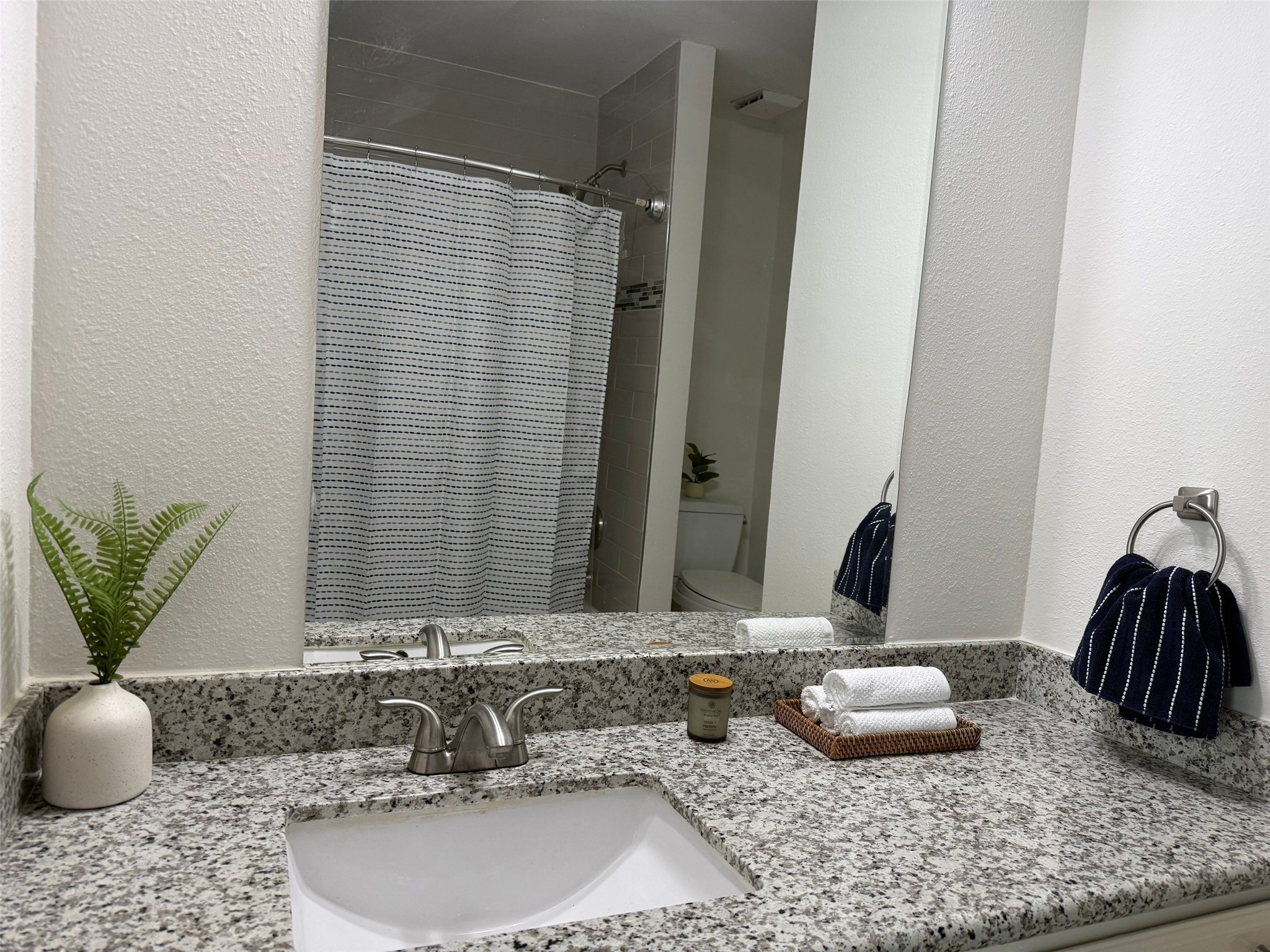 9626 Magnolia Ridge Drive Houston, TX 77070 - Photo 27 of 40 a bathroom with a granite countertop sink and a mirror