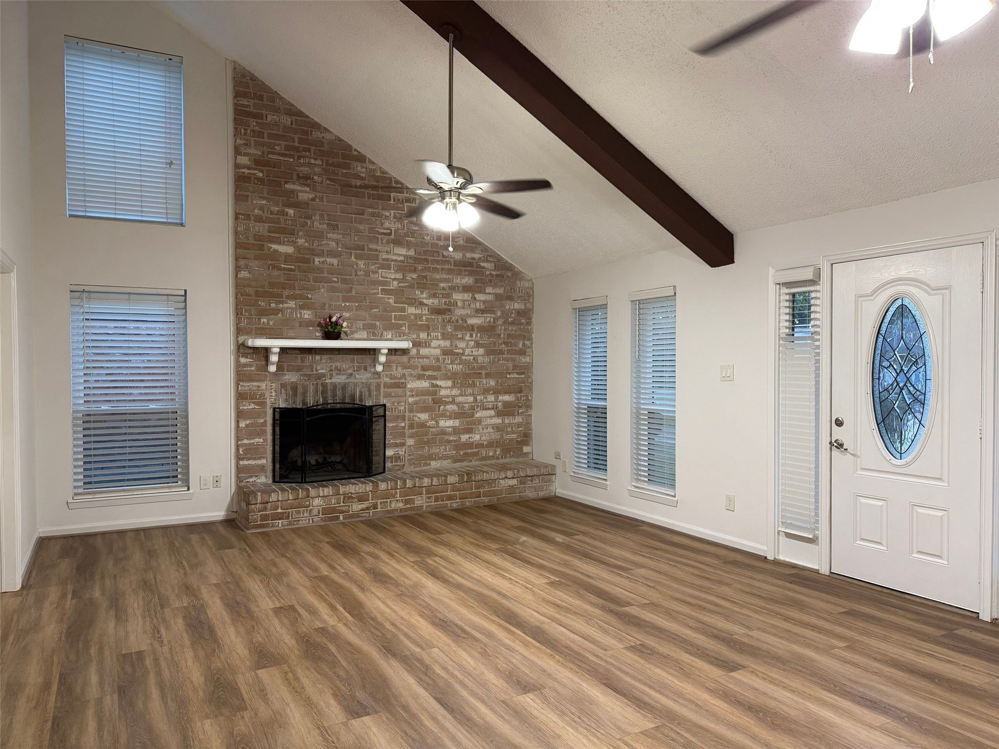 9626 Magnolia Ridge Drive Houston, TX 77070 - Photo 5 of 40 a view of an empty room with wooden floor fireplace and a window