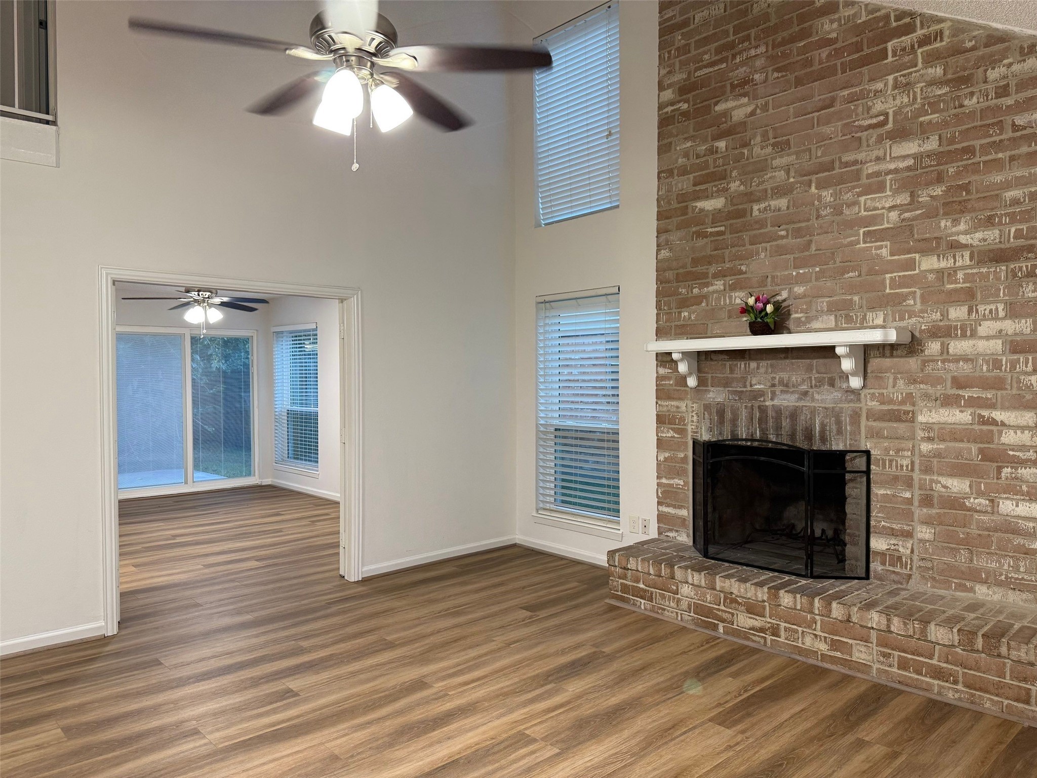 9626 Magnolia Ridge Drive Houston, TX 77070 - Photo 8 of 40 a view of an empty room with wooden floor fireplace and a window
