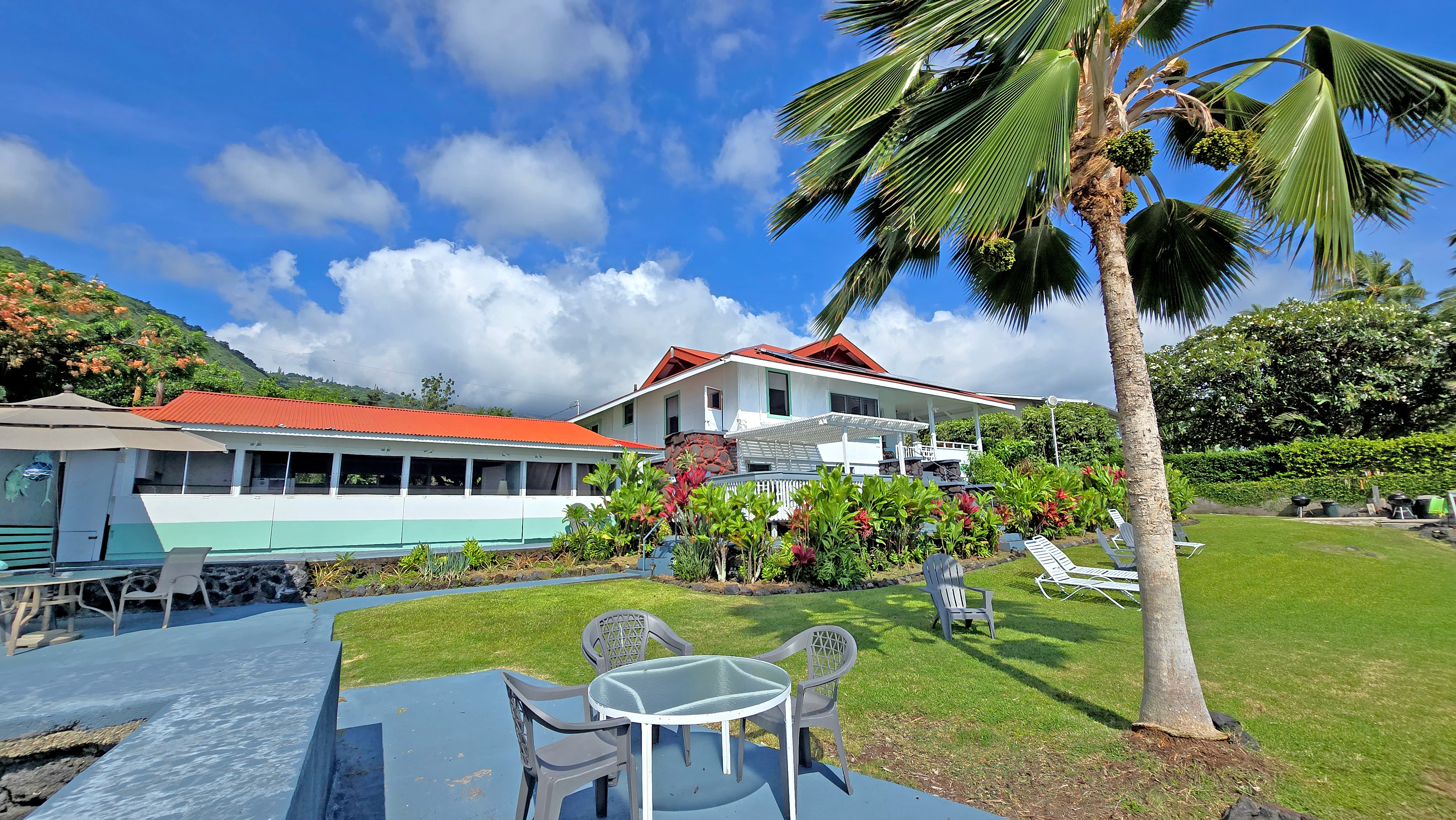 82-6047 Puuhonua Road Captain Cook, HI 96704 - Photo 10 of 25 a view of a house with a yard patio and sitting area