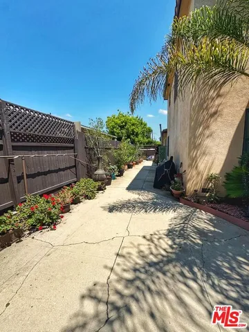 a view of a garden with wooden fence