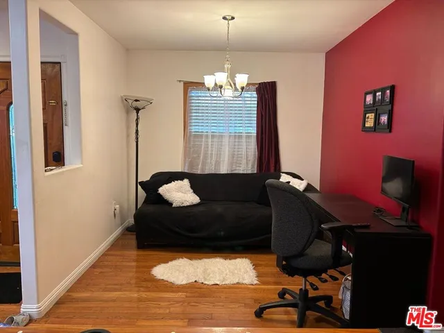 a living room with furniture gym equipment and a chandelier