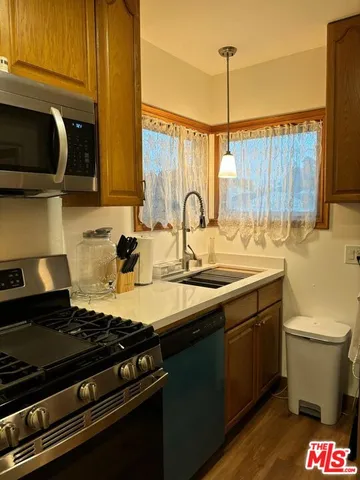 a kitchen with a sink stove and cabinets
