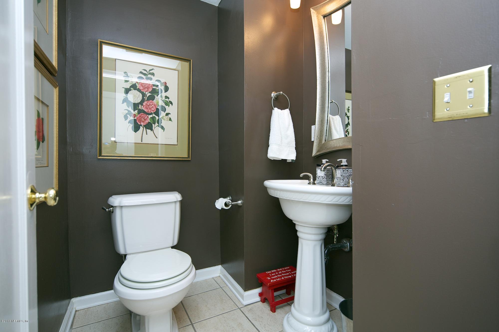 1138 Greenridge Road Jacksonville, FL 32207 - Photo 18 of 36 a bathroom with a toilet a sink and mirror