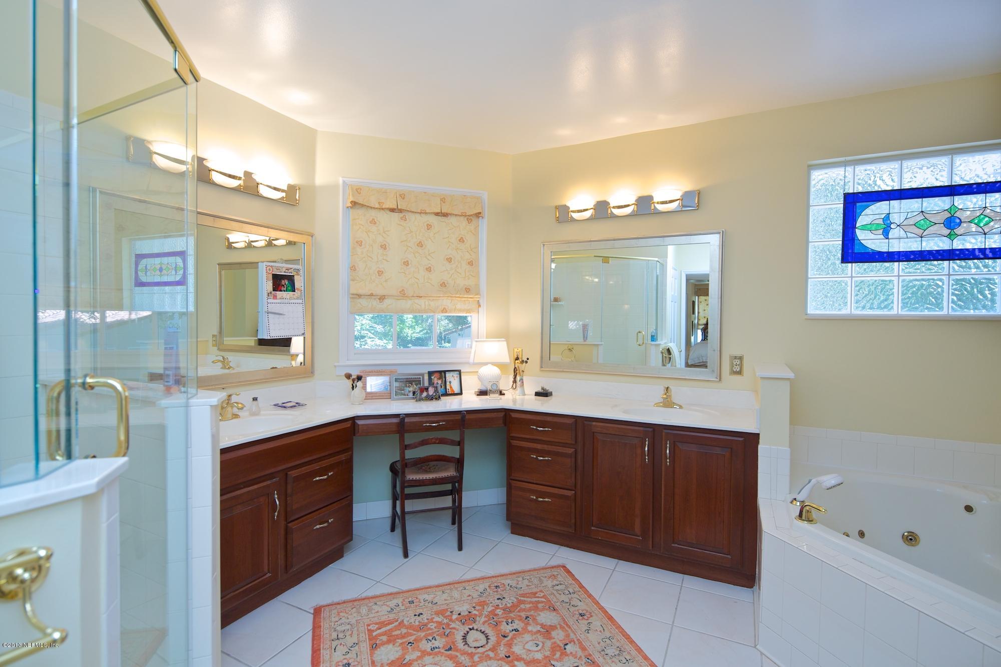 1138 Greenridge Road Jacksonville, FL 32207 - Photo 21 of 36 a spacious bathroom with a tub sink and mirror