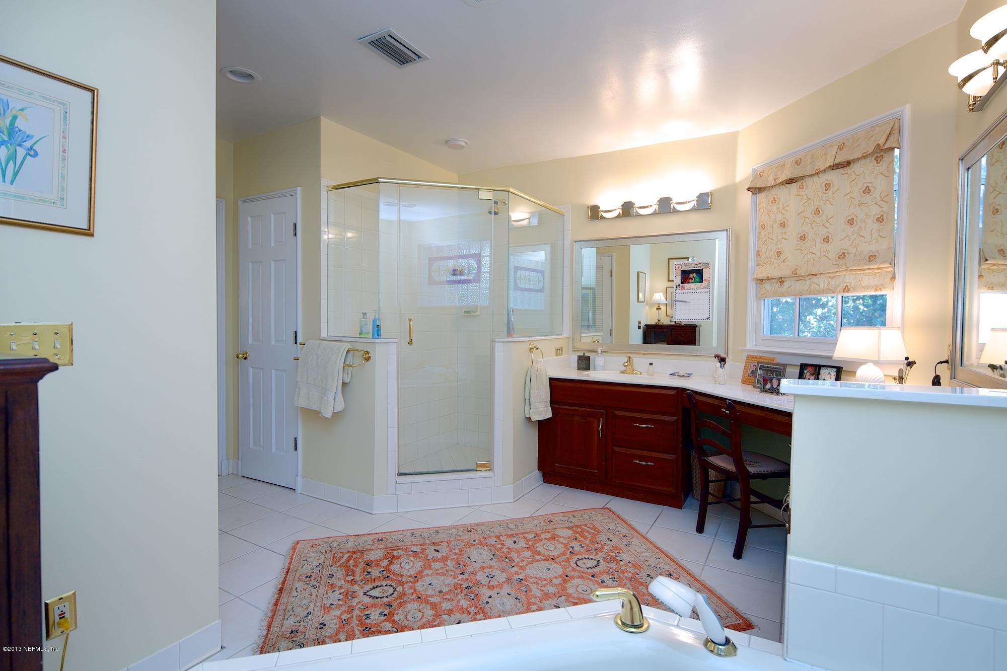 1138 Greenridge Road Jacksonville, FL 32207 - Photo 22 of 36 a spacious bathroom with a sink and a mirror