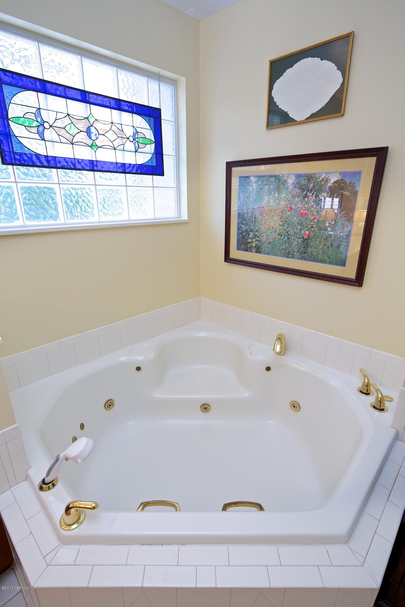 1138 Greenridge Road Jacksonville, FL 32207 - Photo 23 of 36 a bathroom with a bathtub and a window