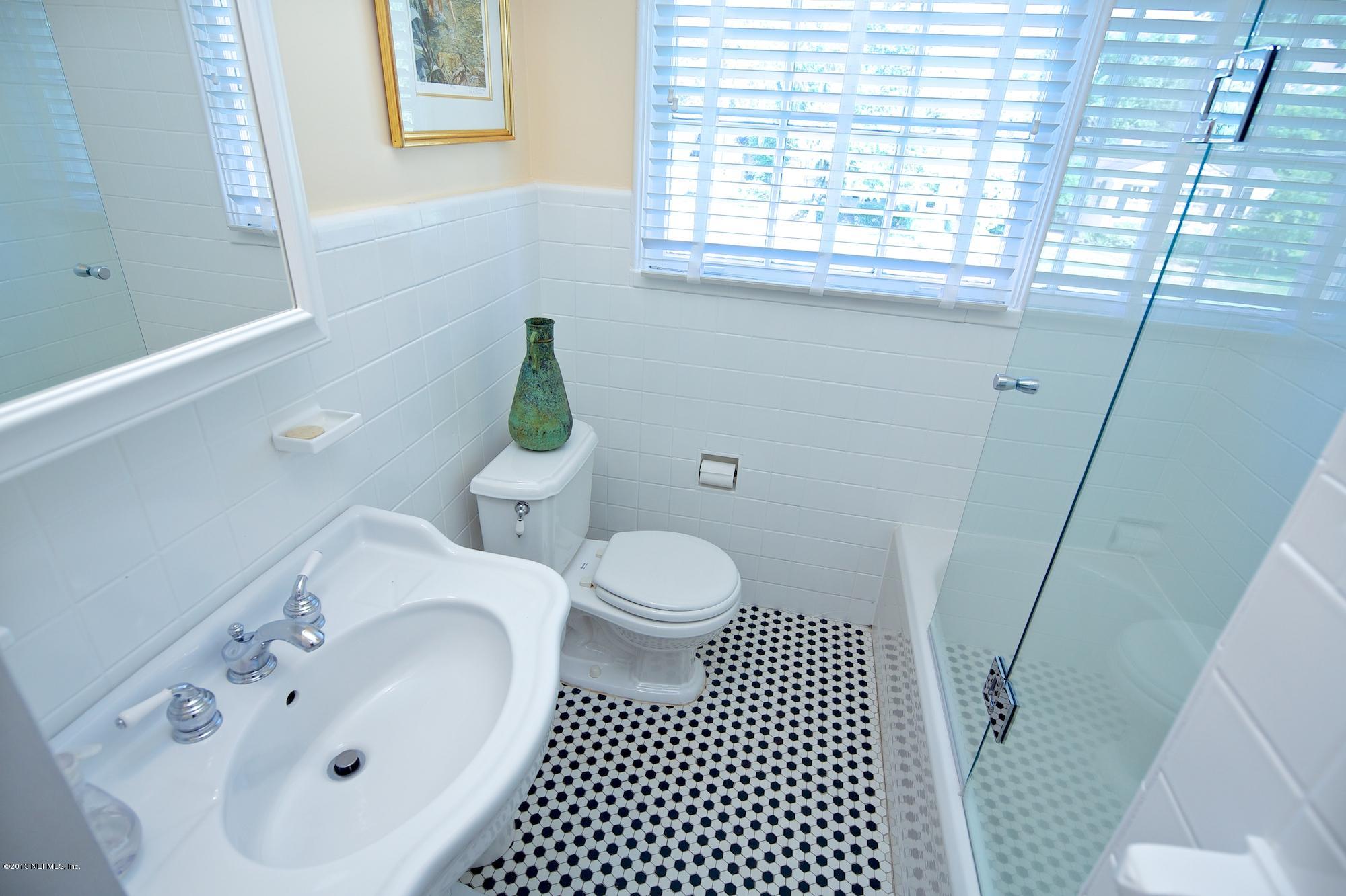 1138 Greenridge Road Jacksonville, FL 32207 - Photo 28 of 36 a bathroom with a sink a toilet and a window