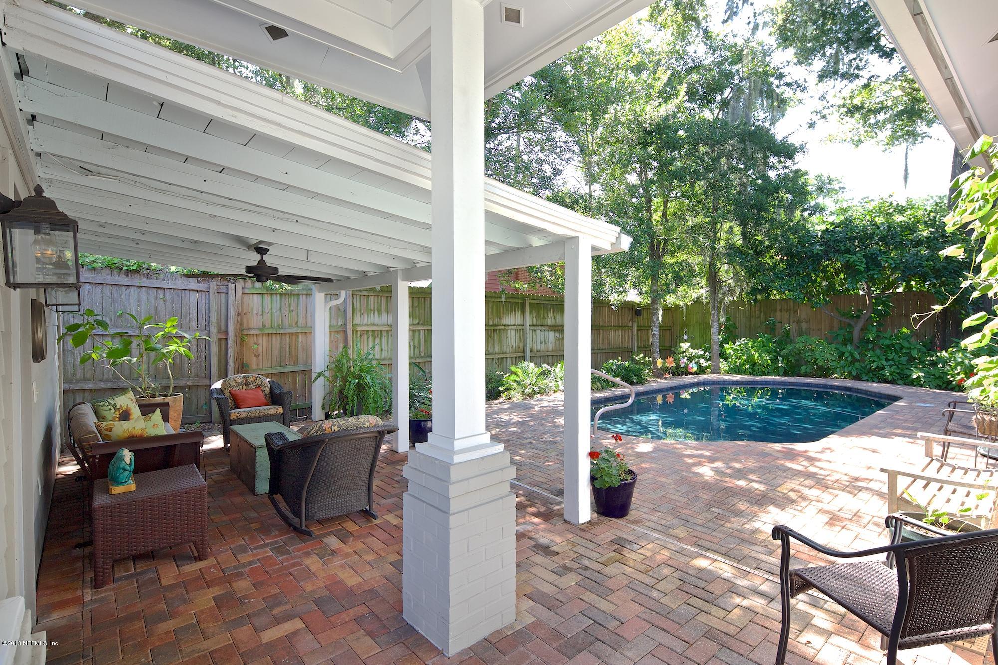 1138 Greenridge Road Jacksonville, FL 32207 - Photo 33 of 36 a view of a patio with table and chairs potted plants and floor to ceiling window