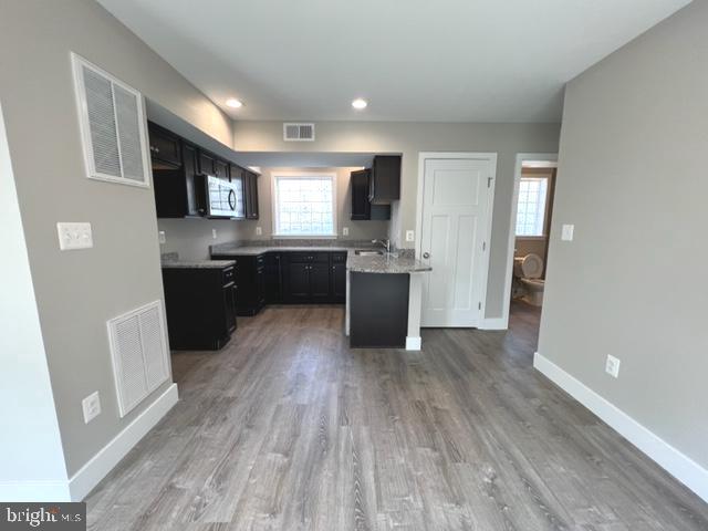 4114 3rd Street, Unit 2 North Beach, MD 20714 - Photo 11 of 24 a large kitchen with wooden floor and stainless steel appliances