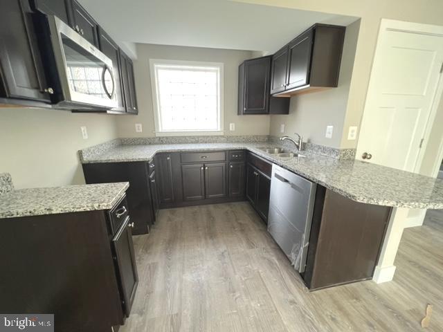 4114 3rd Street, Unit 2 North Beach, MD 20714 - Photo 13 of 24 a kitchen with stainless steel appliances granite countertop a sink stove and refrigerator