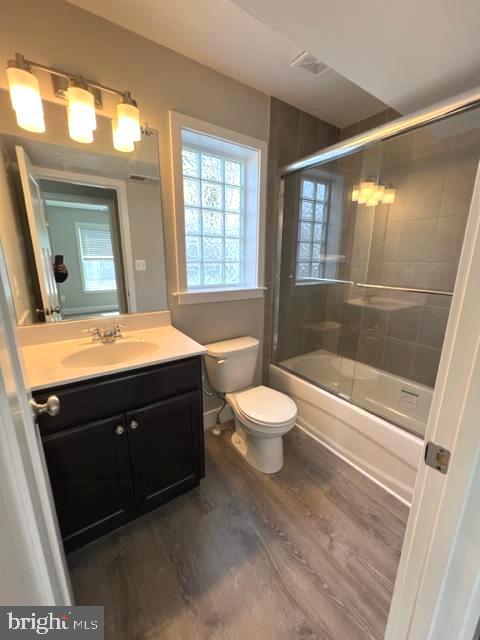 4114 3rd Street, Unit 2 North Beach, MD 20714 - Photo 15 of 24 a bathroom with a sink a toilet a mirror and shower