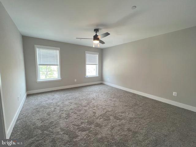 4114 3rd Street, Unit 2 North Beach, MD 20714 - Photo 16 of 24 an empty room with windows and ceiling fan view