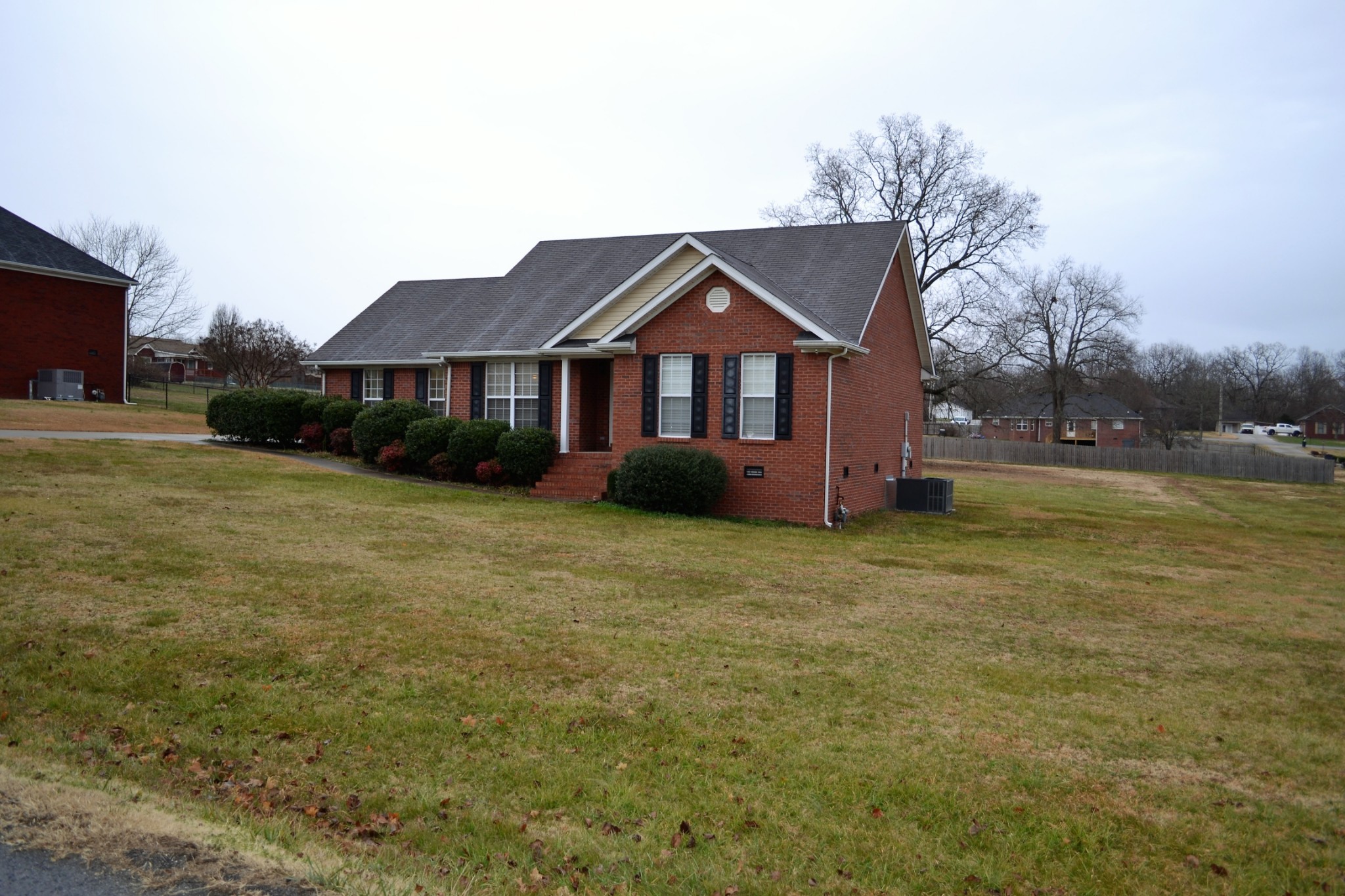 80 Eastridge Road Fayetteville, TN 37334 - Photo 3 of 43 a front view of a house with a garden and trees