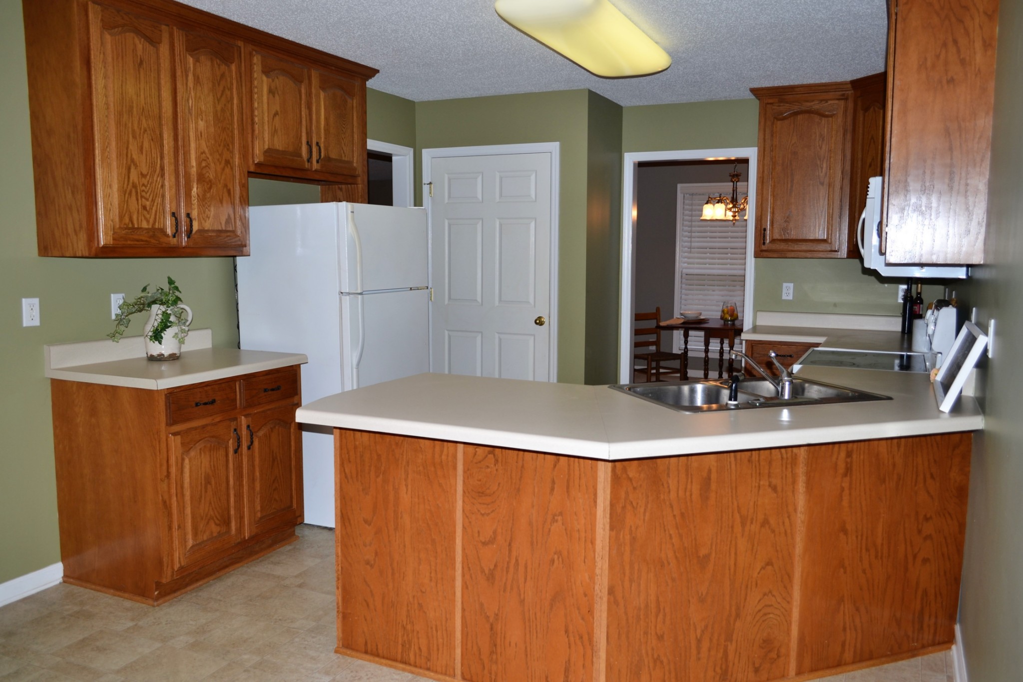 80 Eastridge Road Fayetteville, TN 37334 - Photo 8 of 43 a room with kitchen island a sink cabinets and wooden floor