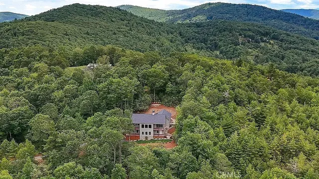 an aerial view of a house with mountain view