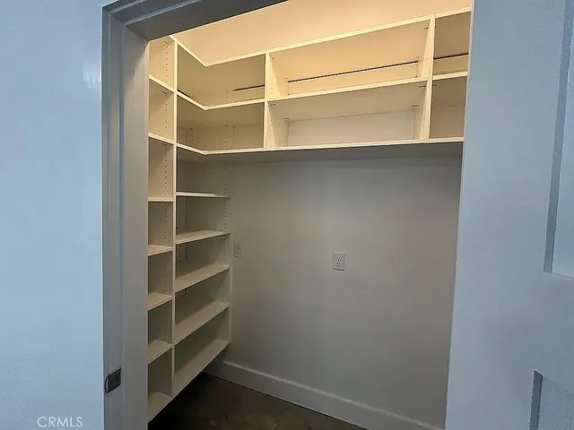 a bathroom with a granite countertop sink a toilet a mirror and shower