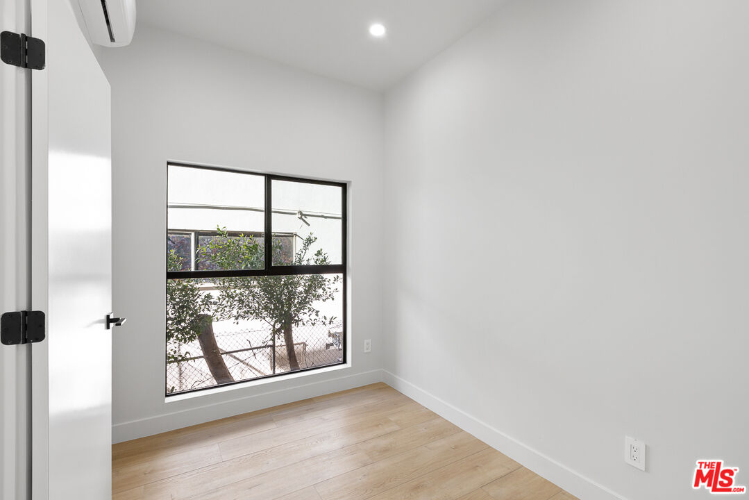 7229 Willoughby Avenue, Unit 8 Los Angeles, CA 90046 - Photo 12 of 14 an empty room with windows