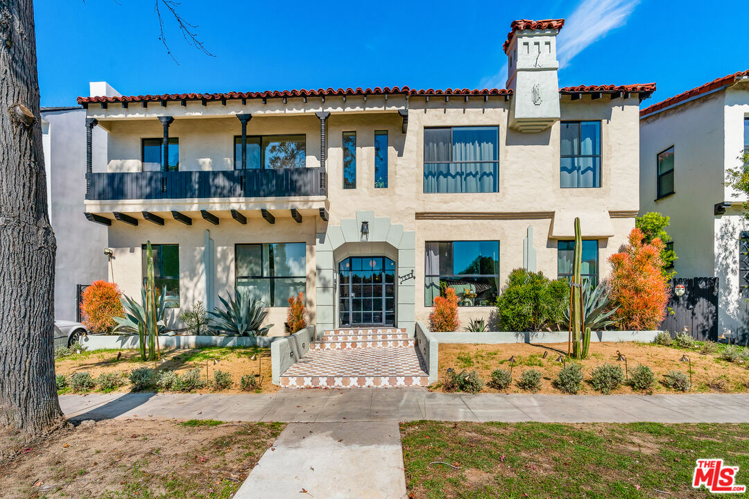 7229 Willoughby Avenue, Unit 8 Los Angeles, CA 90046 - Photo 14 of 14 a front view of a house with a yard