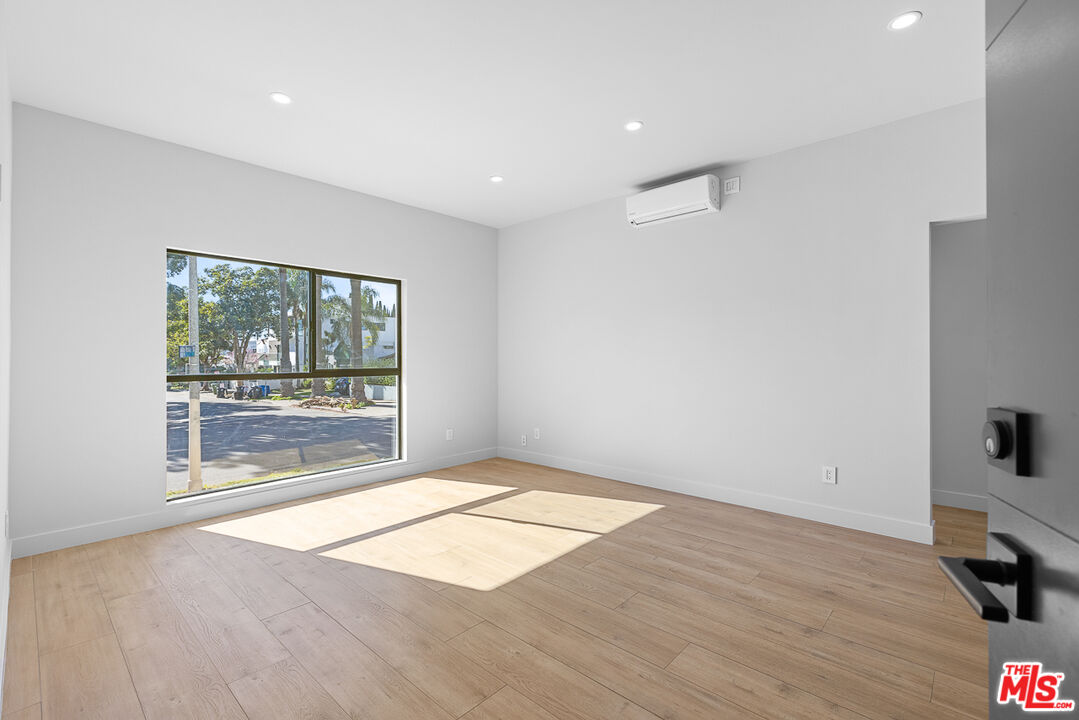 7229 Willoughby Avenue, Unit 8 Los Angeles, CA 90046 - Photo 2 of 14 a view of empty room with wooden floor and fan