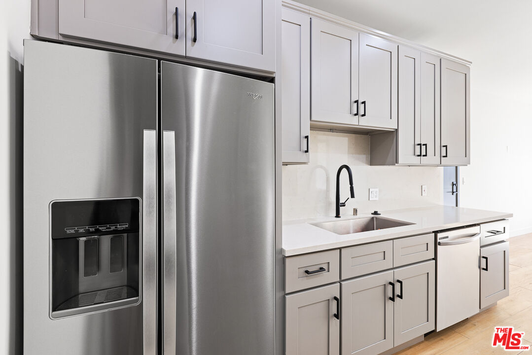 7229 Willoughby Avenue, Unit 8 Los Angeles, CA 90046 - Photo 6 of 14 a kitchen with white cabinets and refrigerator